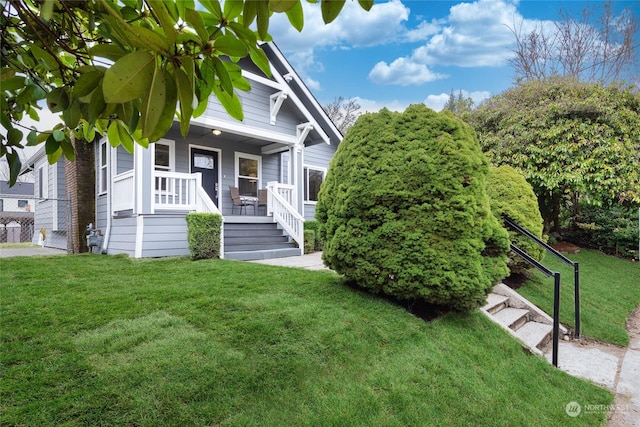 view of front of property featuring covered porch and a front lawn