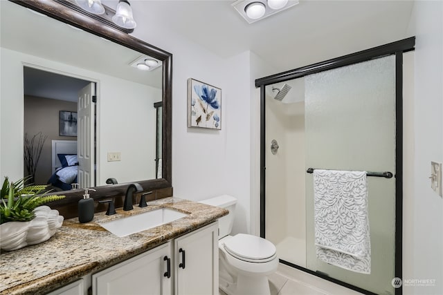 bathroom with tile patterned flooring, vanity, toilet, and walk in shower