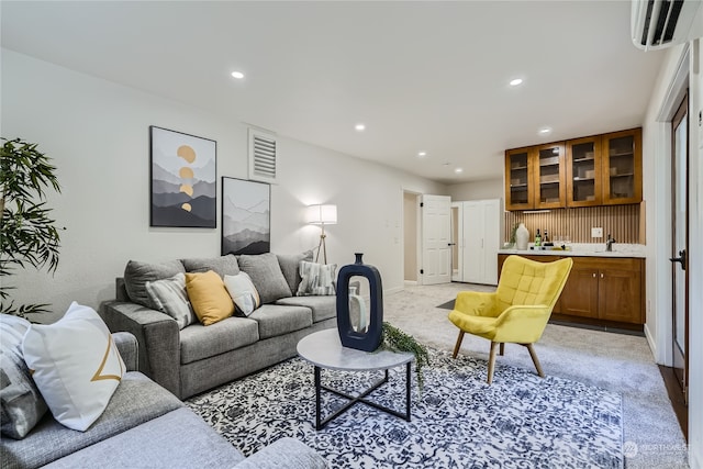 living room with light colored carpet and a wall mounted AC