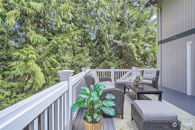 wooden terrace with an outdoor living space