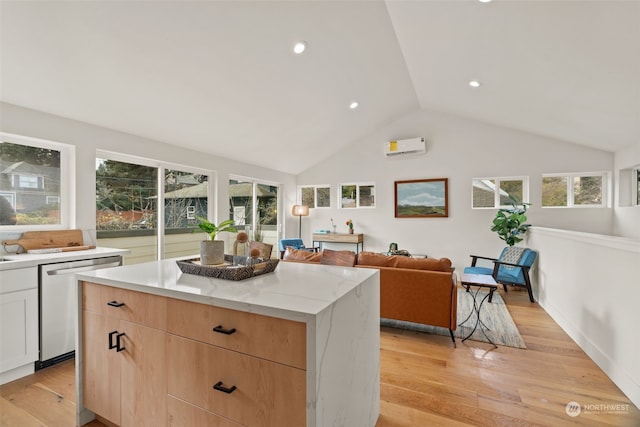 kitchen featuring vaulted ceiling, stainless steel dishwasher, light hardwood / wood-style floors, a kitchen island, and white cabinetry