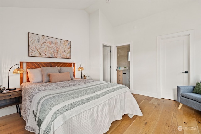 bedroom featuring hardwood / wood-style flooring and lofted ceiling