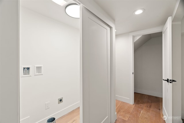 washroom featuring hookup for an electric dryer, washer hookup, and light hardwood / wood-style floors