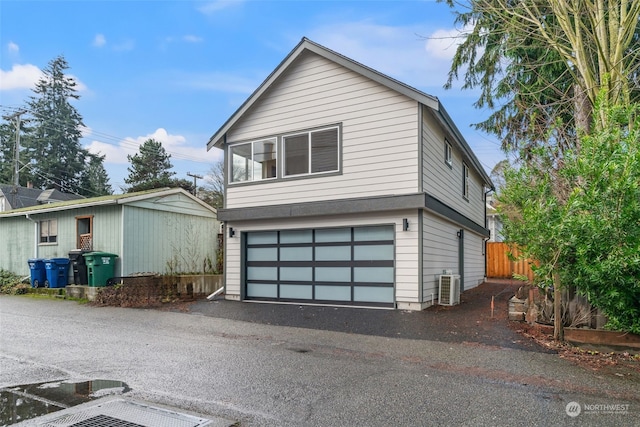 view of front of home featuring central AC unit and a garage