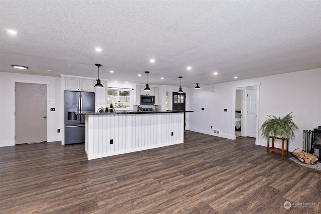 kitchen with stainless steel refrigerator with ice dispenser, dark wood-type flooring, white cabinetry, and pendant lighting