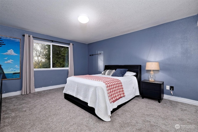 bedroom with carpet flooring and a textured ceiling