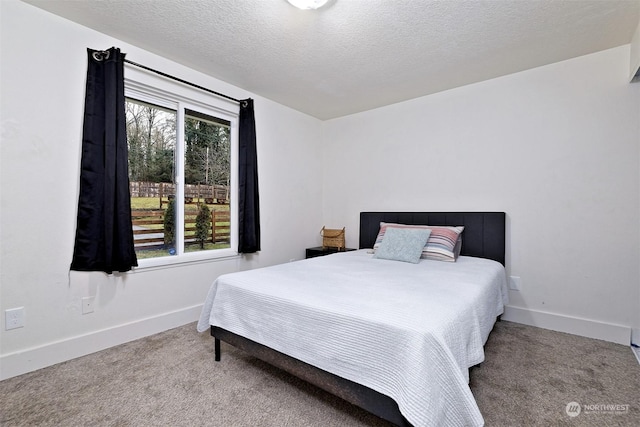 bedroom featuring carpet floors and a textured ceiling