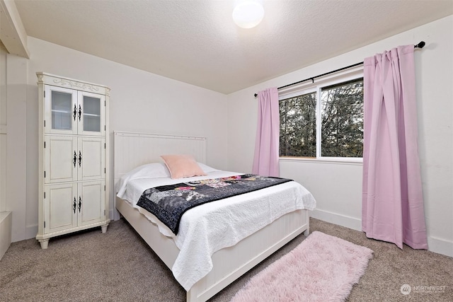 bedroom with light carpet and a textured ceiling