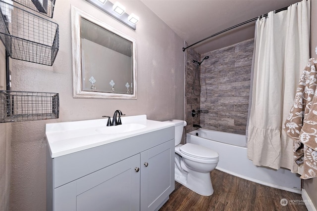 full bathroom with vanity, hardwood / wood-style floors, shower / bathtub combination with curtain, and toilet