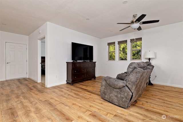 living room featuring ceiling fan and light wood-type flooring