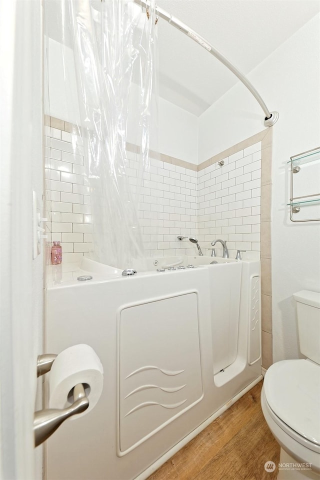 bathroom featuring hardwood / wood-style floors and toilet