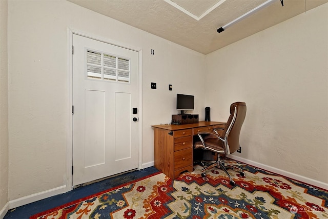 office area with a textured ceiling