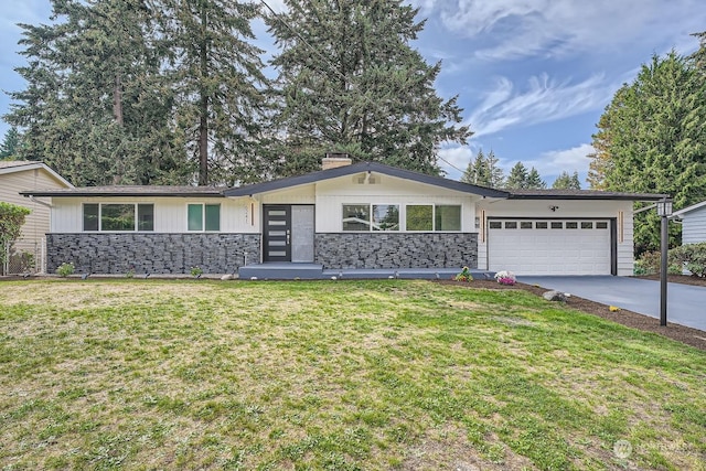 single story home with a garage and a front lawn