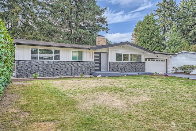 ranch-style house featuring a garage and a front lawn