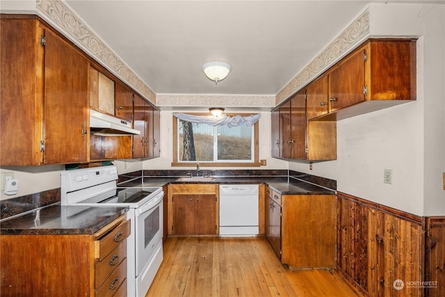 kitchen featuring light wood-type flooring, white appliances, and sink