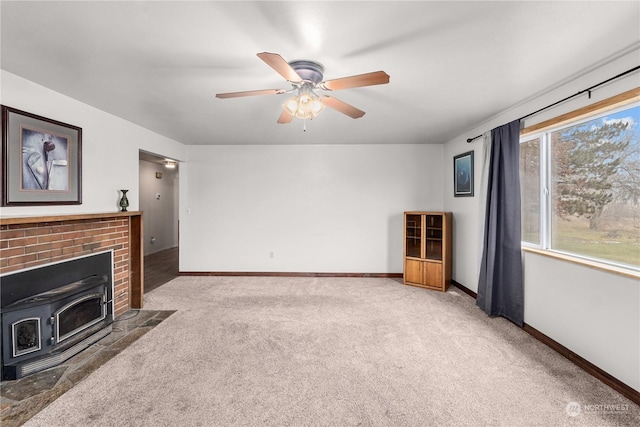 living room with a wood stove, ceiling fan, and carpet