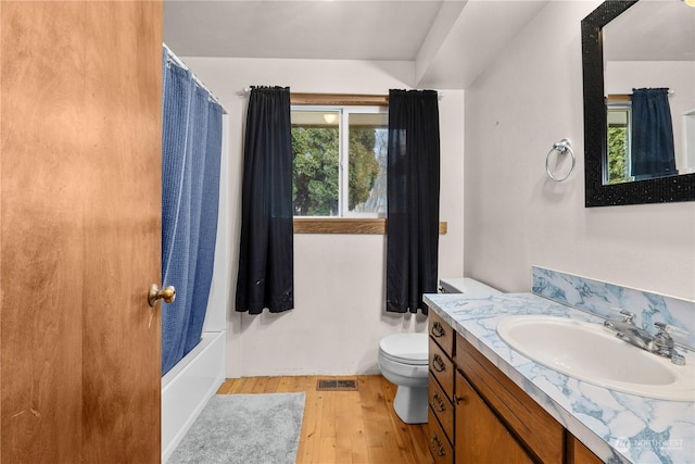 full bathroom with toilet, vanity, shower / tub combo, and hardwood / wood-style flooring