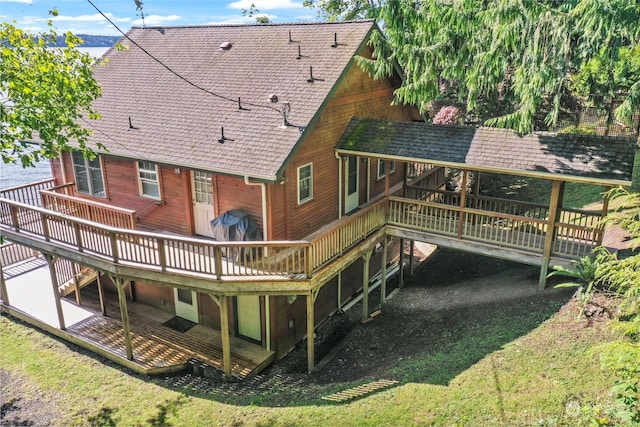 back of house featuring a yard and a wooden deck