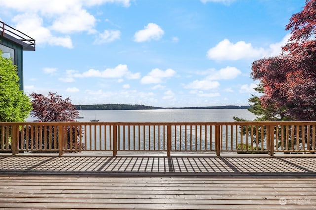 wooden terrace featuring a water view