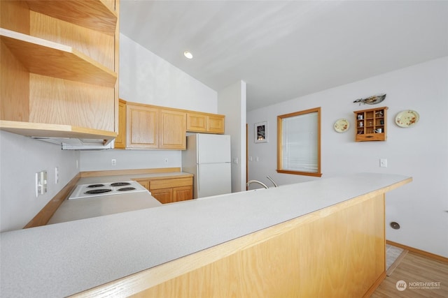 kitchen featuring kitchen peninsula, light wood-type flooring, white appliances, light brown cabinets, and lofted ceiling