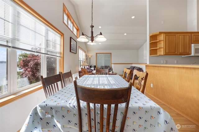 dining space featuring a notable chandelier and lofted ceiling