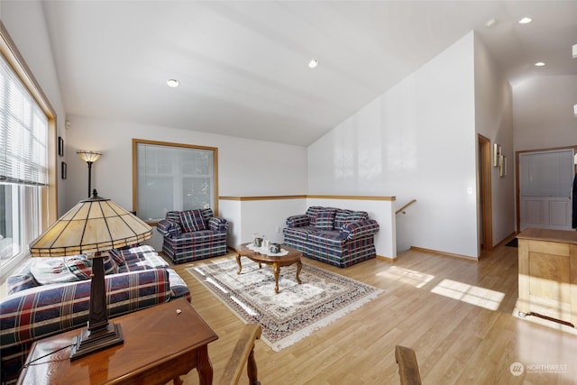 living room with lofted ceiling and light wood-type flooring