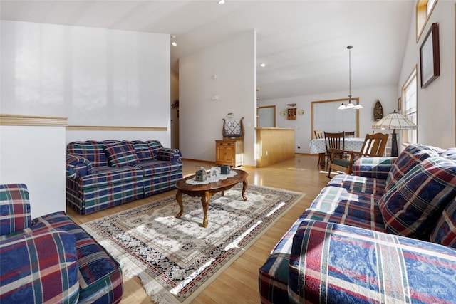 living room with a chandelier and light wood-type flooring