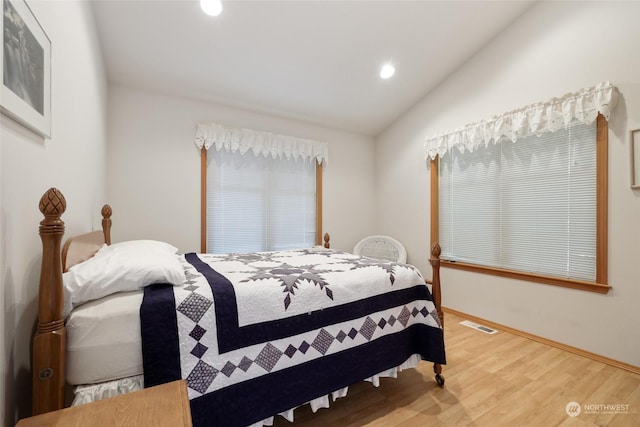 bedroom with hardwood / wood-style flooring and vaulted ceiling