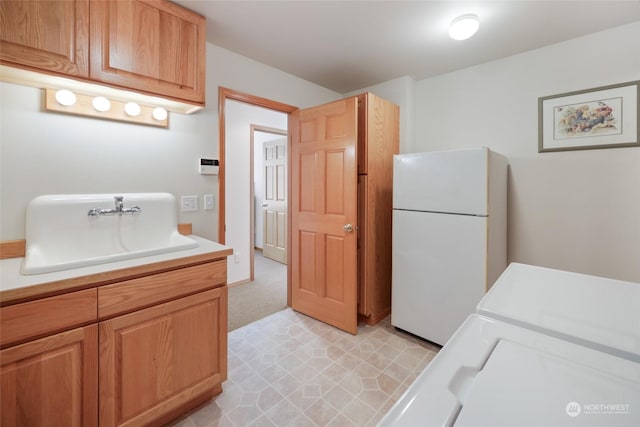 interior space featuring white fridge, light colored carpet, and sink