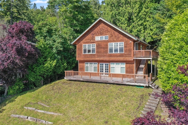 back of house featuring a lawn and a deck