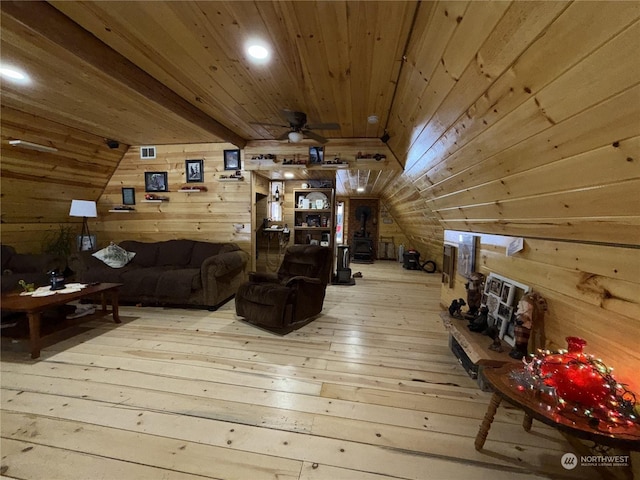 living room featuring wooden walls, wood-type flooring, and vaulted ceiling