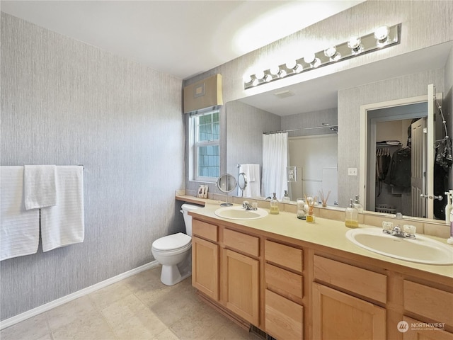 bathroom with toilet, a shower with shower curtain, and vanity