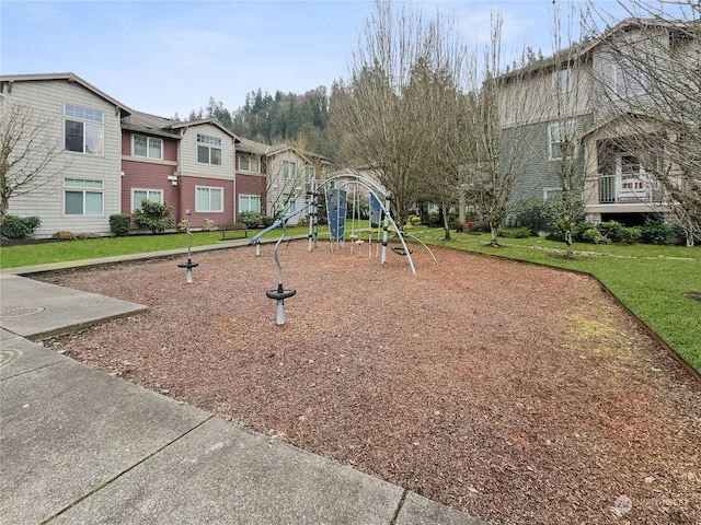 view of jungle gym featuring a lawn