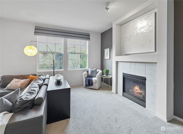 carpeted living room featuring a tiled fireplace