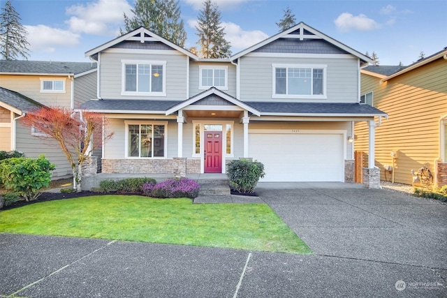 craftsman inspired home with a garage and a front lawn