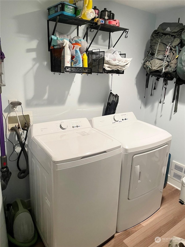 4105 Stone Way N, Seattle, WA 98103 - clothes washing area with light wood-type flooring and washing machine and clothes dryer