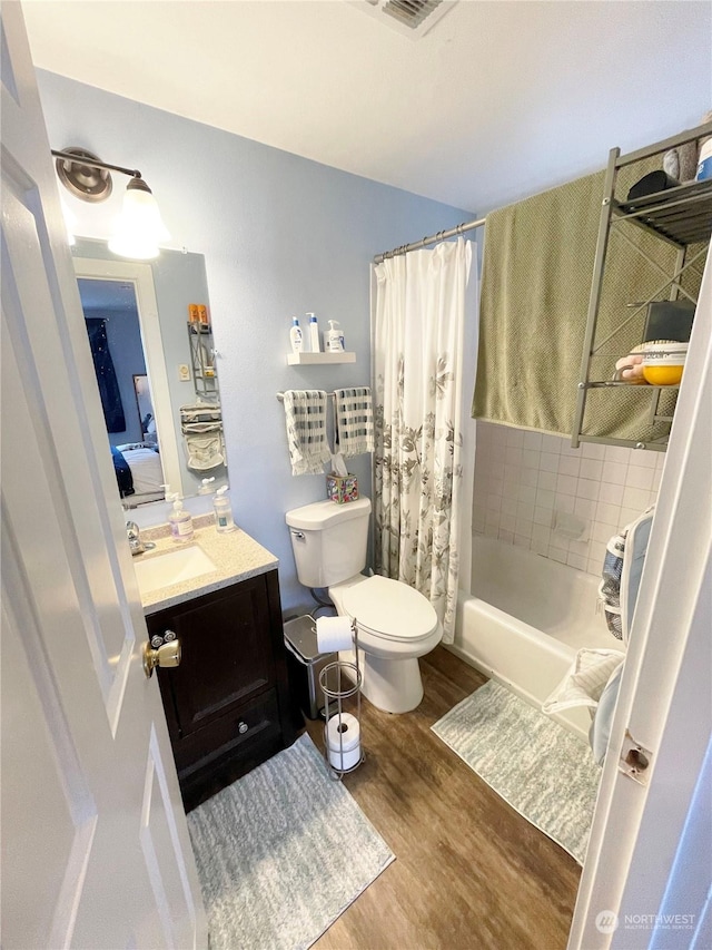 4105 Stone Way N, Seattle, WA 98103 - full bathroom featuring hardwood / wood-style floors, vanity, shower / bath combination with curtain, and toilet