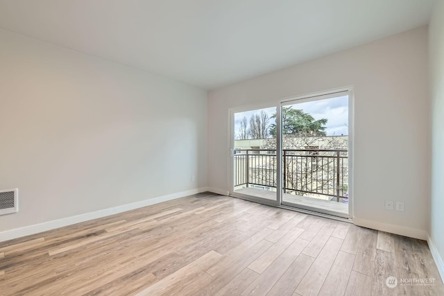 unfurnished room with light hardwood / wood-style flooring