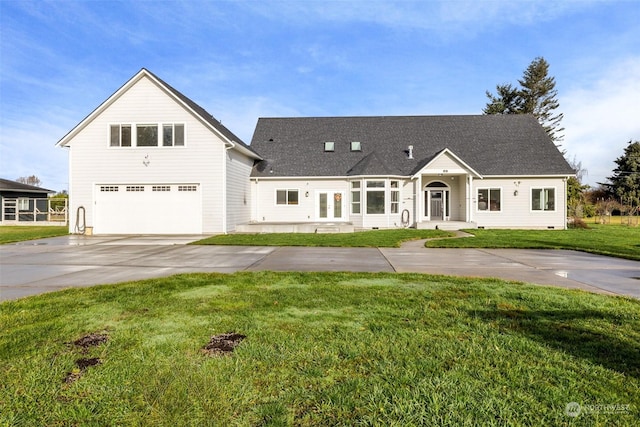 view of front of house featuring a front yard and a garage