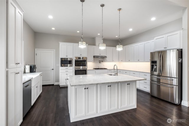 kitchen with a kitchen island with sink, white cabinets, hanging light fixtures, sink, and appliances with stainless steel finishes