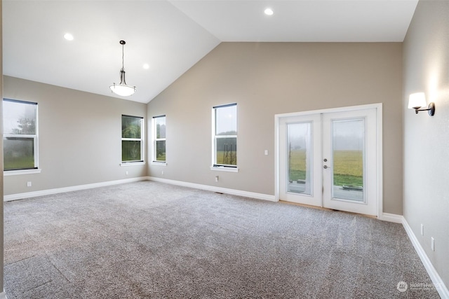 unfurnished room with carpet flooring, french doors, and high vaulted ceiling