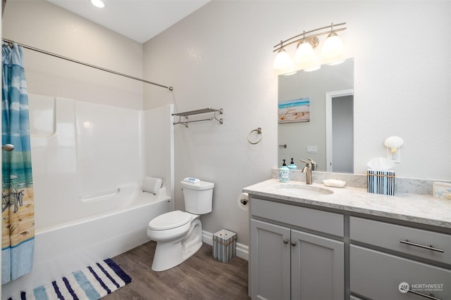 full bathroom with hardwood / wood-style floors, vanity, shower / bath combo, and toilet