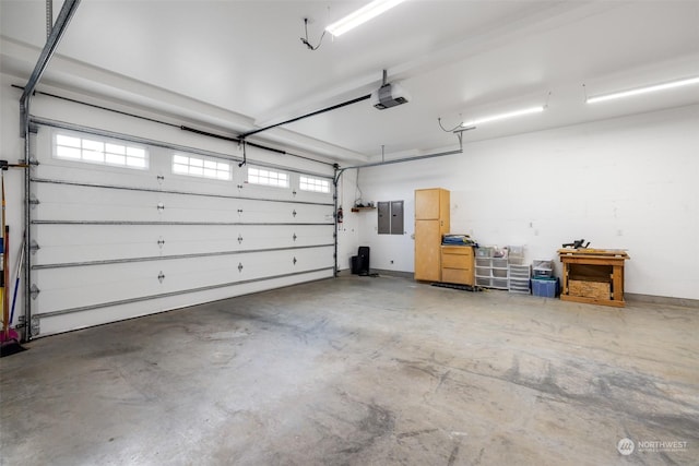 garage featuring electric panel and a garage door opener