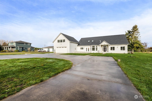 view of front of property featuring a front lawn and a garage