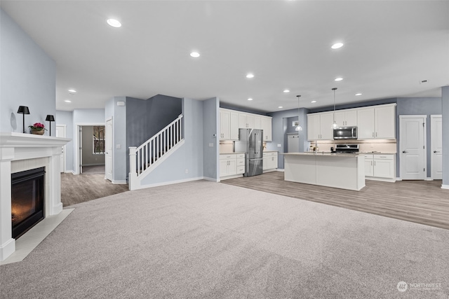 unfurnished living room featuring wood-type flooring