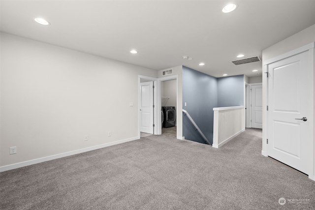 carpeted empty room with washer / dryer