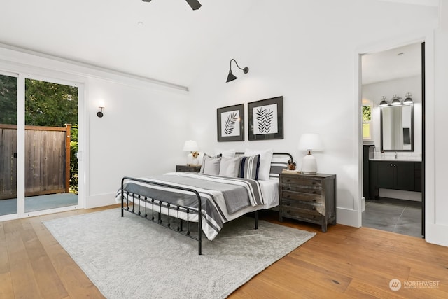 bedroom featuring ceiling fan, multiple windows, ensuite bath, and access to outside