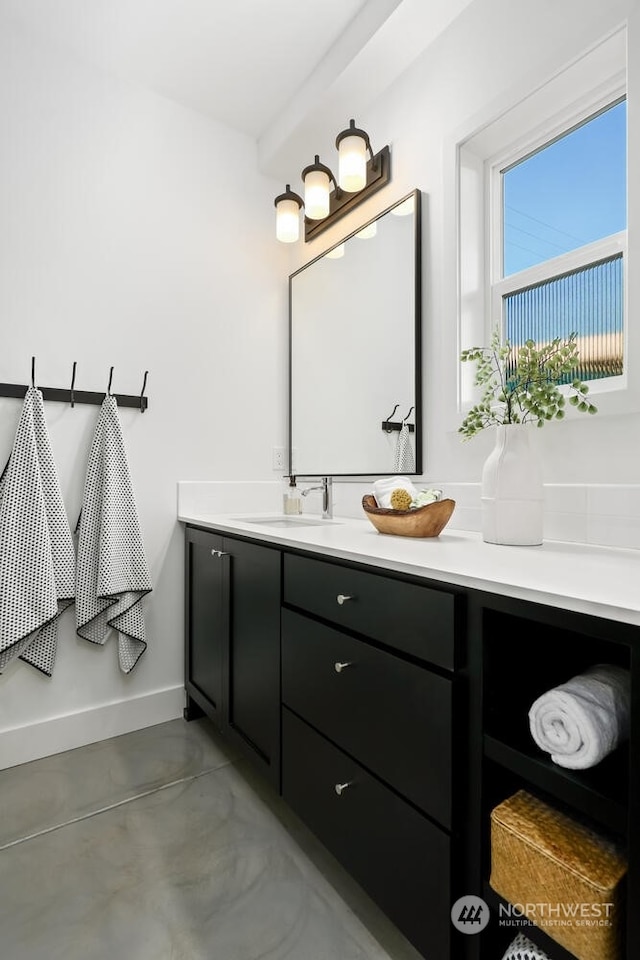 bathroom with concrete floors and vanity