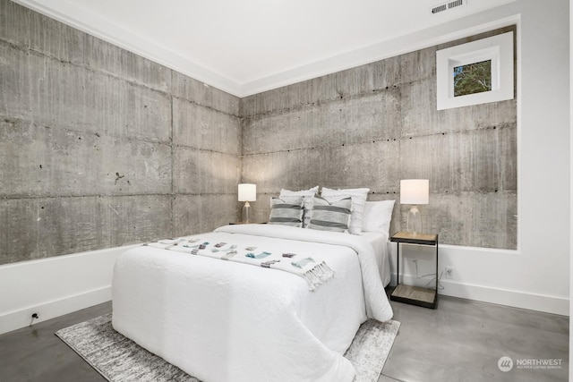 bedroom featuring concrete flooring