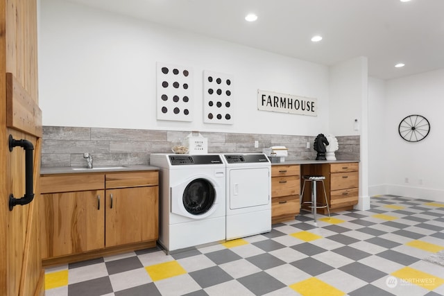 laundry area with cabinets, sink, and washing machine and dryer